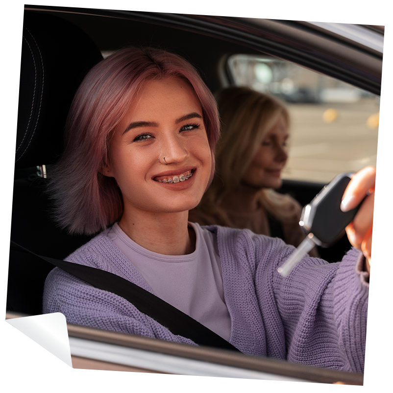 young girl in car holding car key